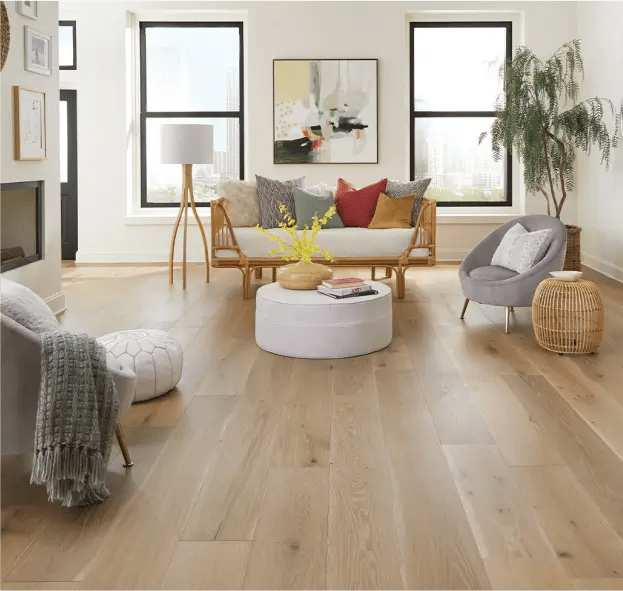 A brightly lit room with furniture placed on tan luxury hardwood flooring by Southern Luxe.