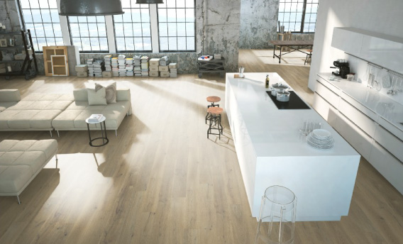 Light sandalwood flooring from expert hardwood flooring suppliers ties a modern kitchen together.